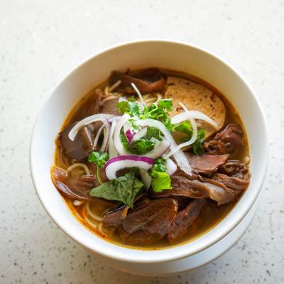Bowl of Vietnamese beef noodle soup served on the table.