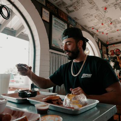 People having a meal at the table with the view at the interior in the background.