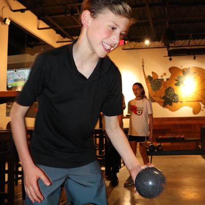 A child bowling.