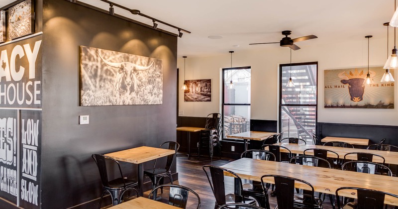 Interior, large dining area, wooden top tables for six and two, ceiling fans, windows