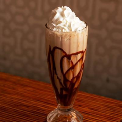 Chocolate milkshake topped with whipped cream.