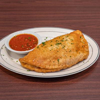 Calzone, with marinara sauce.