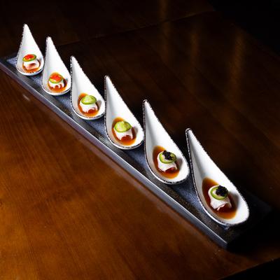 Yellowtail Jalapeno appetizer spoons on a board.