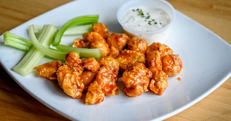Sweet Thai chili chicken strips served with celery sticks and a white sauce