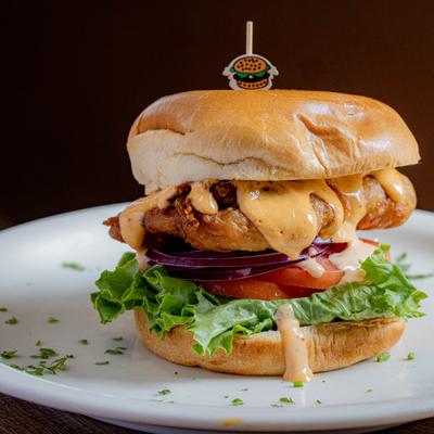 Masa Fried Chicken Sandwich layered with tomato and lettuce.