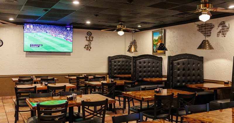 Interior dining area with upholstered dining booths, tables and chairs