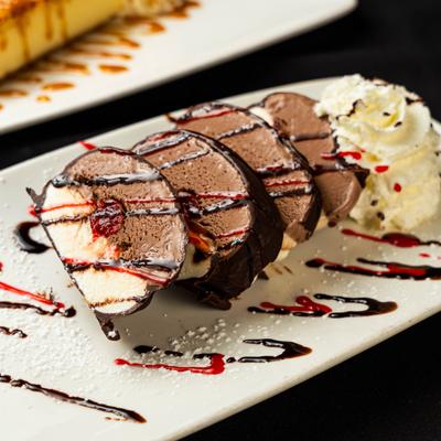 Italian Tartufo ice cream dessert slices served with whipped cream.