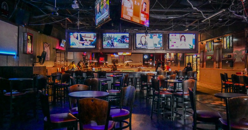 Sport bar interior, seating area, high tables and stools