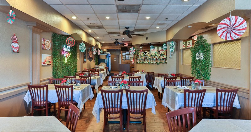 Interior, dining area, white cloth tables for four, ceiling fan, tile flooring