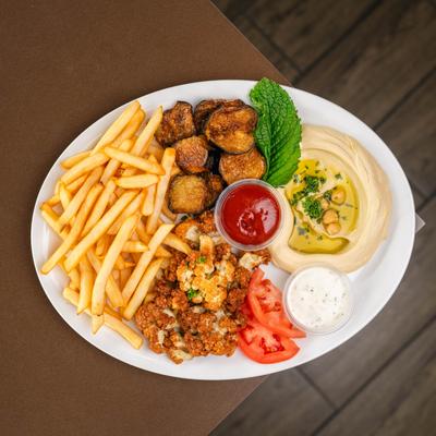 Fried cauliflower served with French fries, hummus, fried eggplant, and sauces.