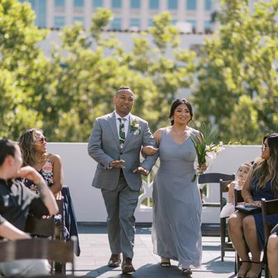 Bride and groom walking down aisle at wedding party.