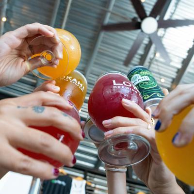 Hands toasting with colorful drinks.
