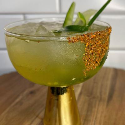A green colored wine cocktail drink.