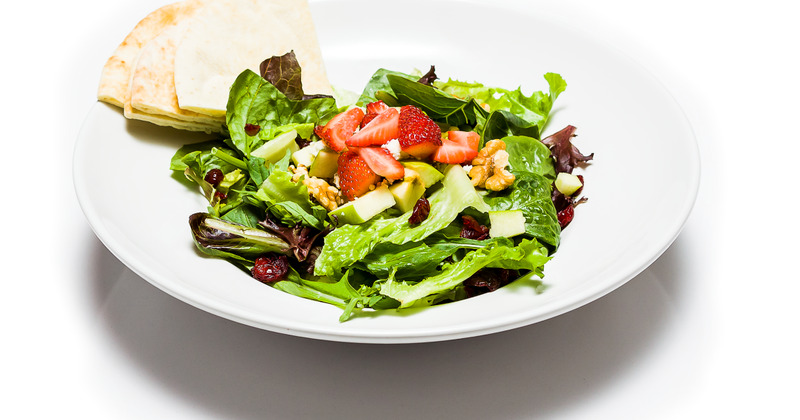Mixed green salad with strawberries and walnuts