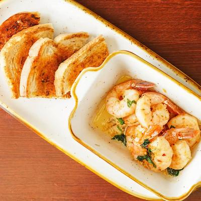 Garlic lemon butter shrimp served with toasted bread.