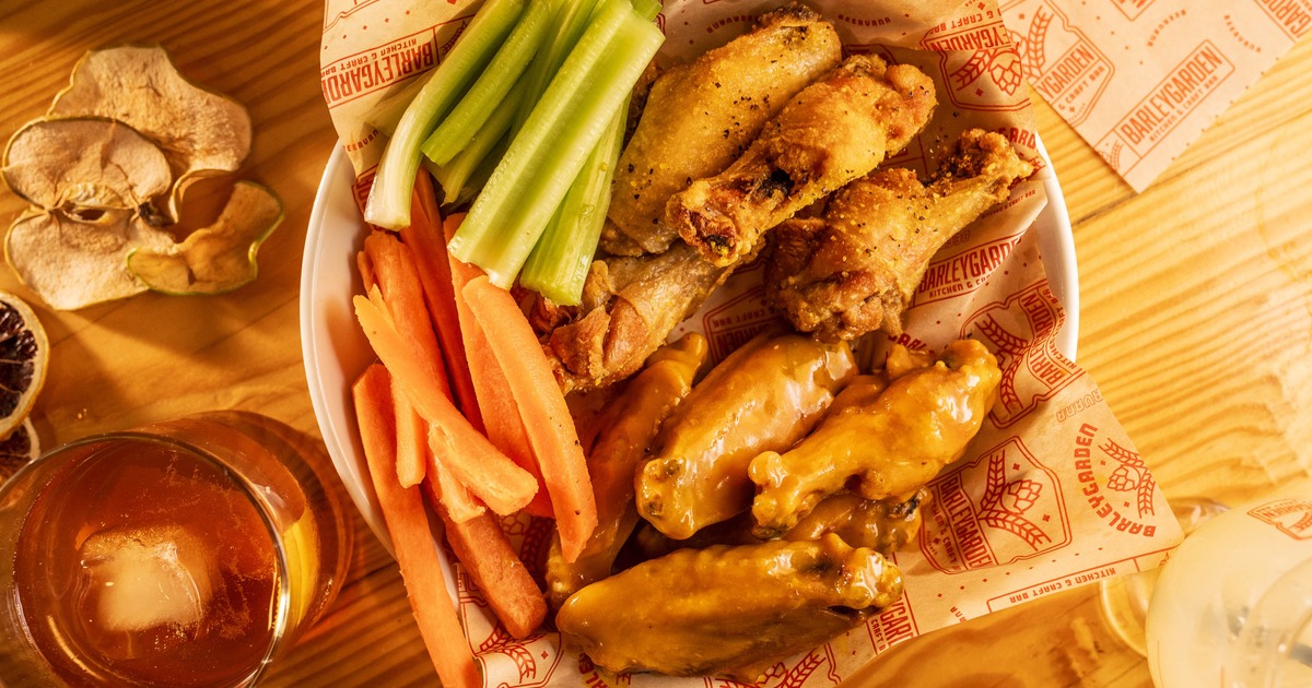 Platter of chicken wing served with carrot and celery sticks