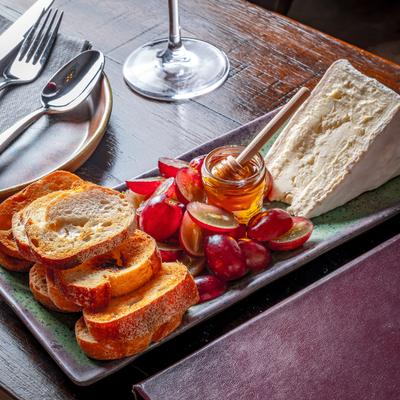 Cream cheese with grapes, honey, and toasted baguette.