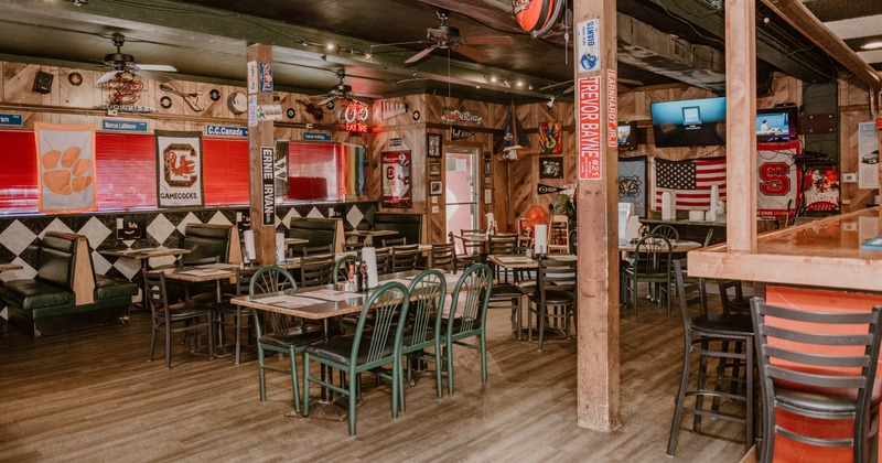 Dining space with booths, tables and chairs and a bar