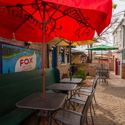 Exterior seating area, red parasols.
