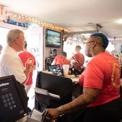 Interior, staff talking to a guest.