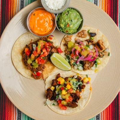 Assorted tacos, and sauces.