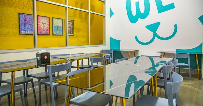 Colorful interior with glass tables and art on the wall