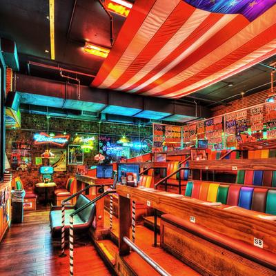 Vibrant retro diner with colorful booths, neon signs, and vintage decor