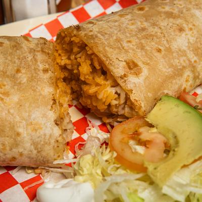 Burrito served alongside a side salad.