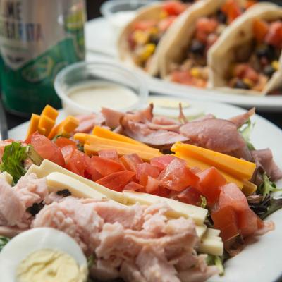 Chef salad, with ham, turkey, tomato, lettuce, cheddar, and boiled egg.