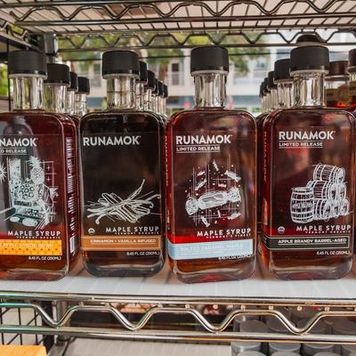 Maple syrup bottles on a store shelf.