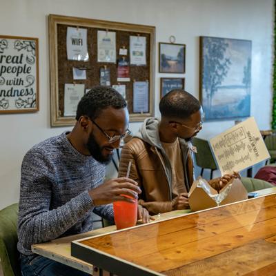 Two persons havng drinks at the bar.