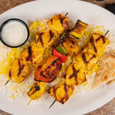 Chicken Shish Kabob, on a bed of rice, and served with pita and tzatziki sauce.