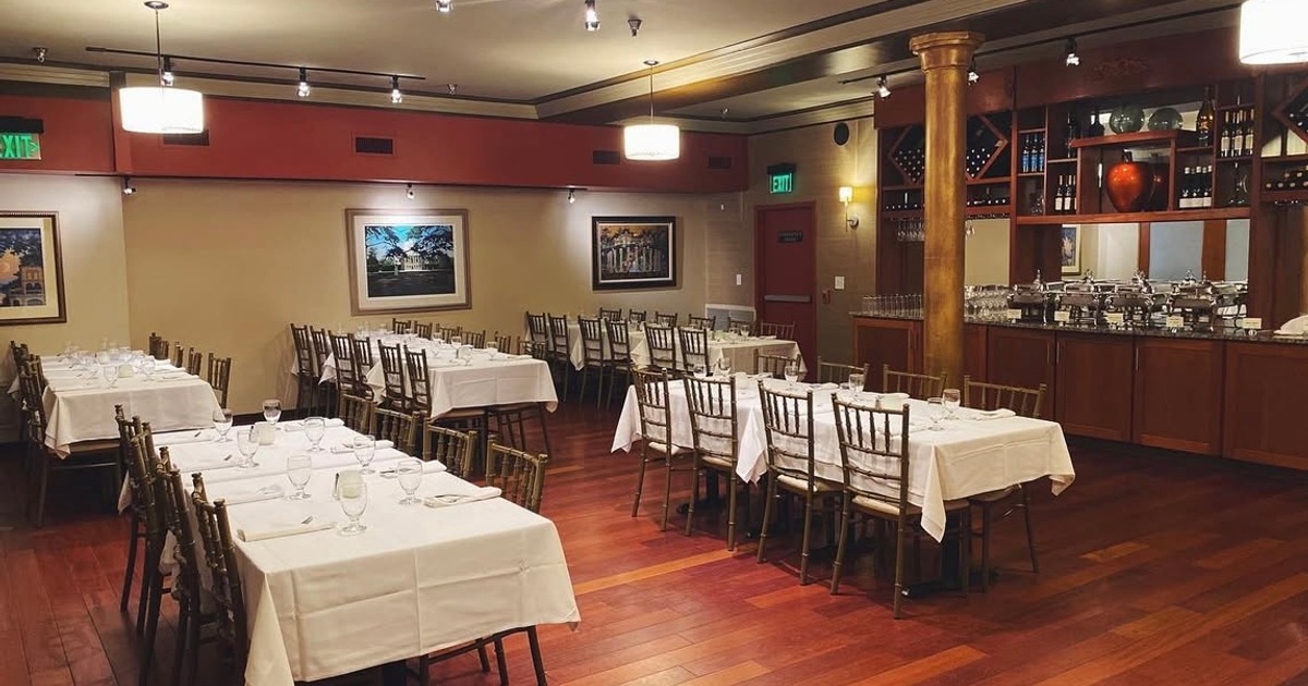 Dining room with set tables, chairs, wall decorations and a counter