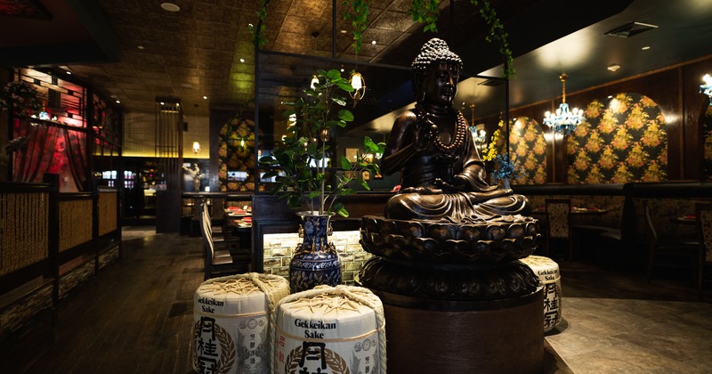 Interior, booth seating, dining tables, decorative sake barrels