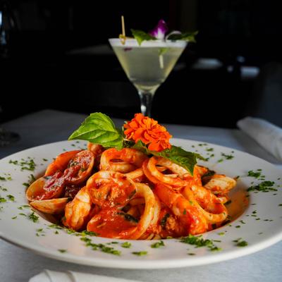 Calamari with tomato sauce and basil, accompanied with a Martini cocktail.