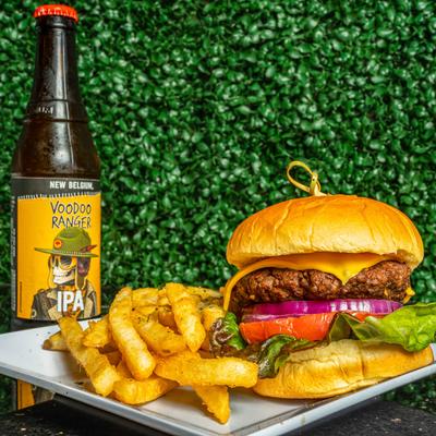 Fried chicken sandwich with fries on the side and the Truth beer.