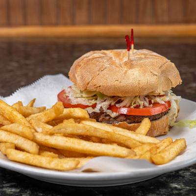 Burger served with fries on a paper-lined plate.