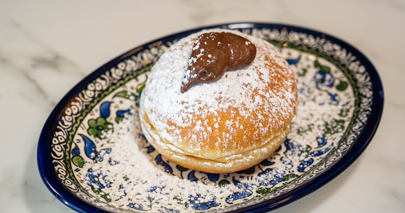 Bombolone with chocolat and powdered sugar