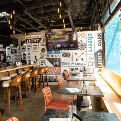 Interior featuring vibrant graphic walls and orange seating.