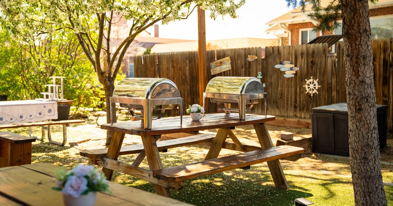 Lined up aluminium trays of grilled sausages, mashed potatoes and other dishes