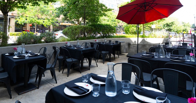 Exterior, patio, metal tables and chairs with black table cloth, ready for guests
