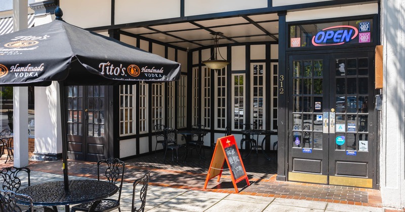 Exterior, entrance, part of garden in  front, tables, chairs and parasols