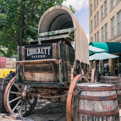 A carriage parked outside of the tavern.