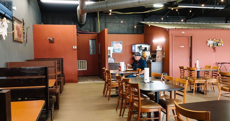 Interior dining area with tables, chairs and wooden booths
