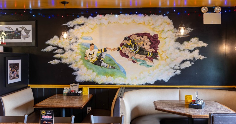 Interior, booth seating, mural on the wall