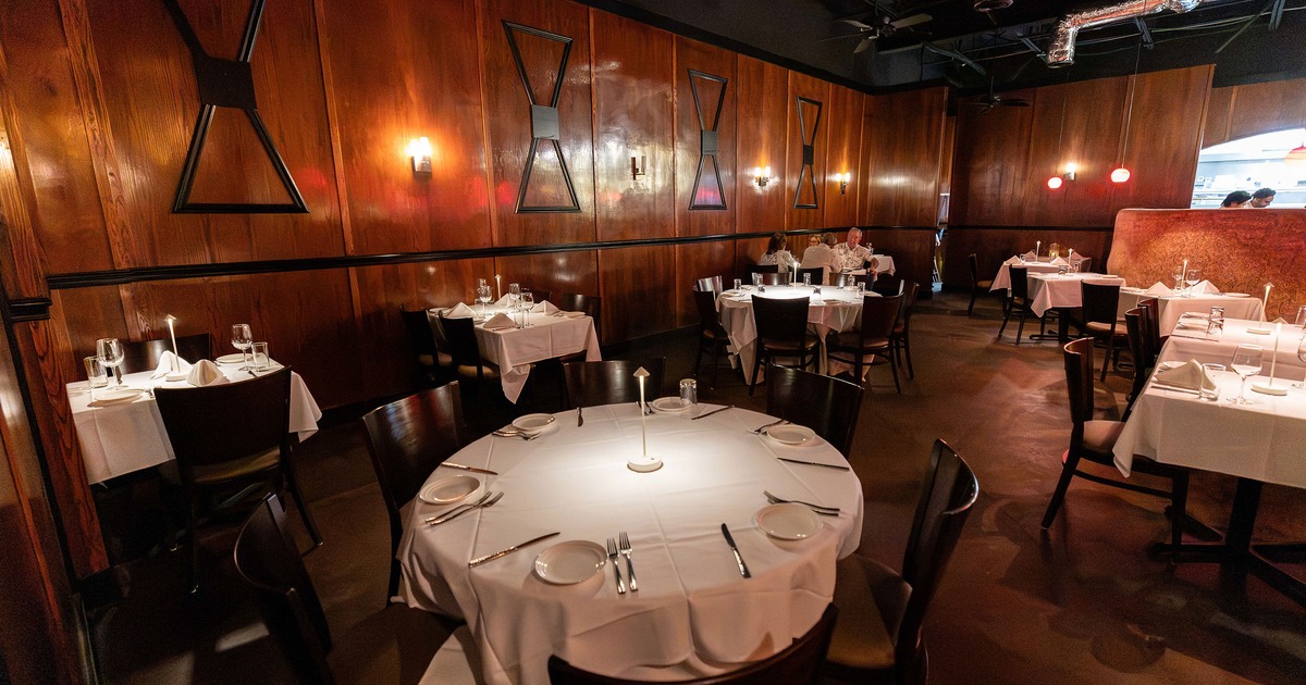 Elegant restaurant dining room with dining tables set for guests