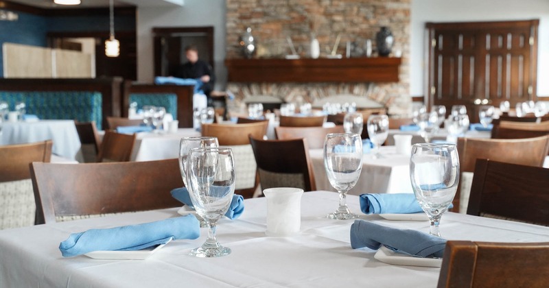 Interior, dining area with tables set for guests