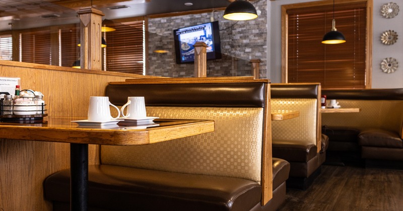 Seating leather booths and wooden tables