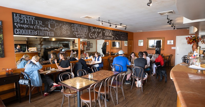 Interior, dining area with guests chatting and enjoying their food and drinks