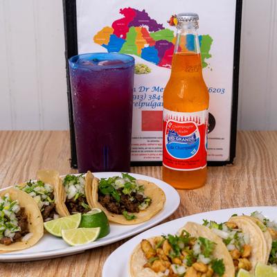 Beef and chicken tacos, with sodas on the side